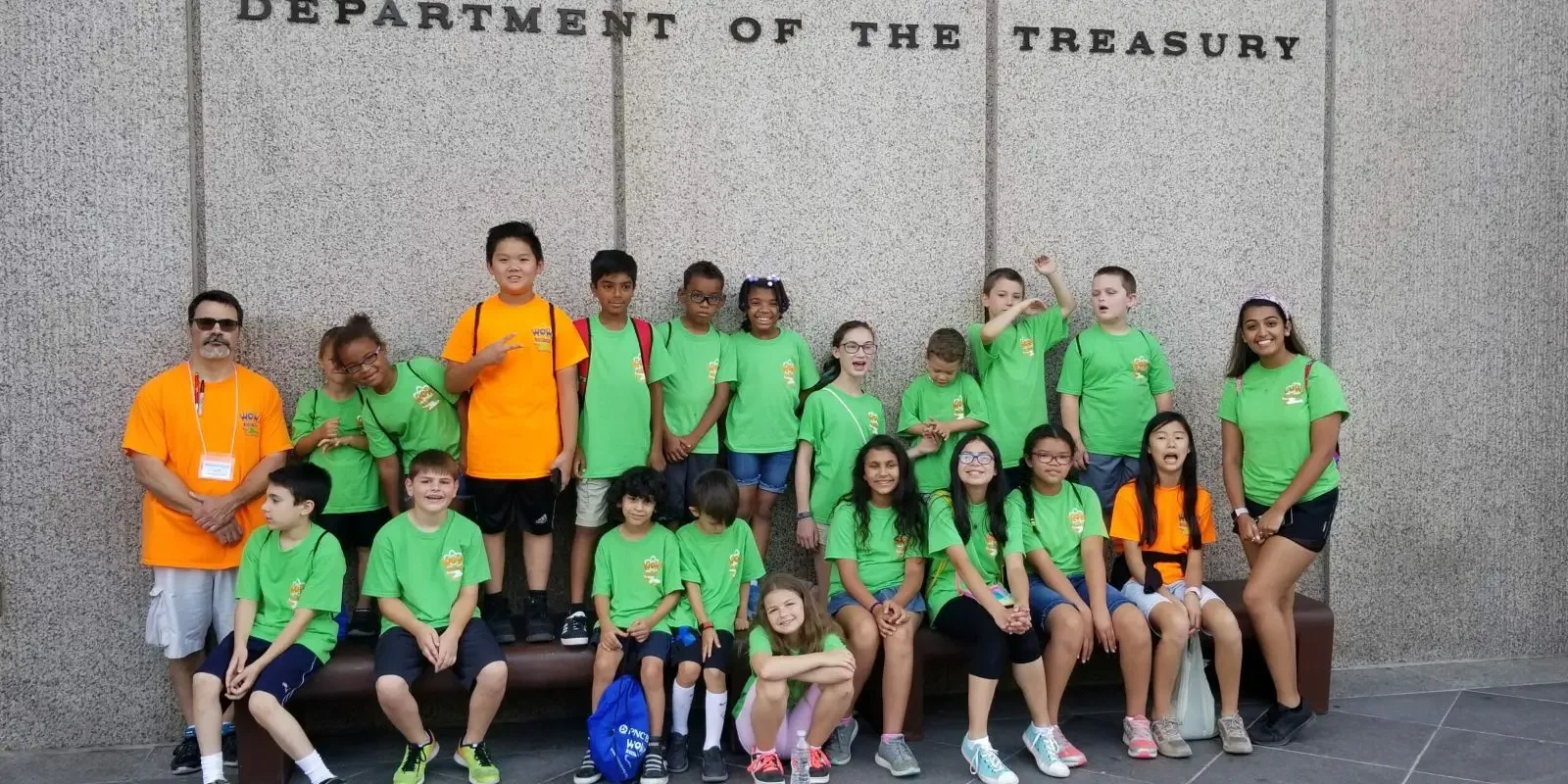 A group of people in green shirts and shorts.